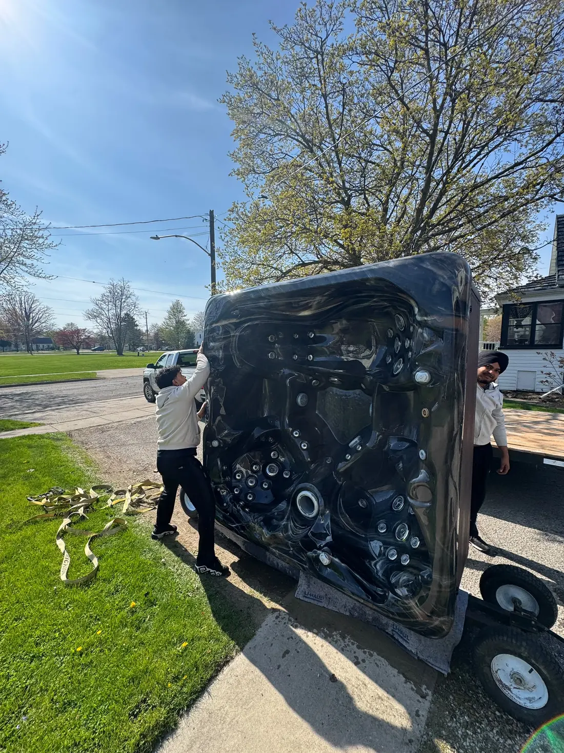 Hot tub being loaded at the curb