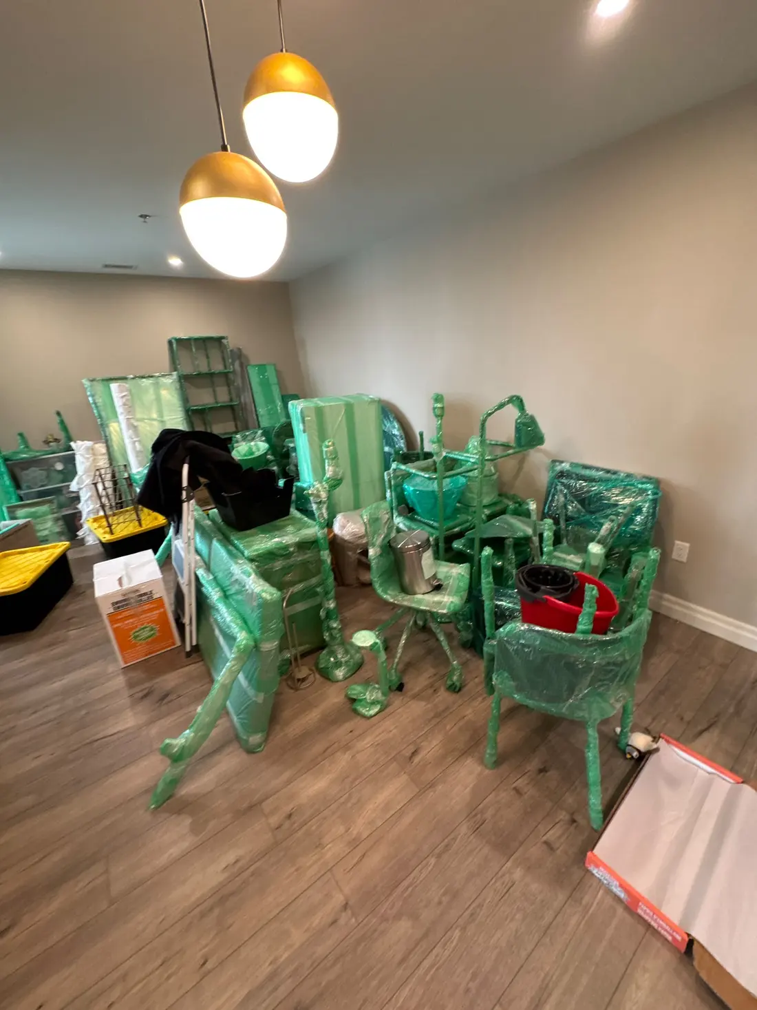 Chairs and tables padded and grouped for a local move