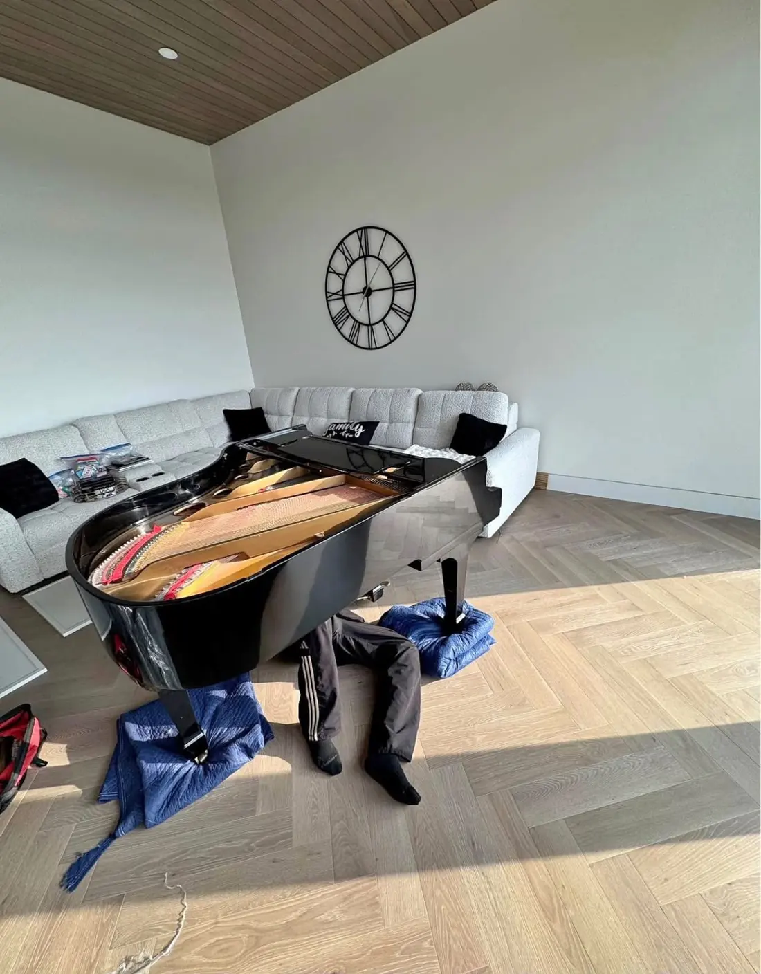 Grand piano protected with moving blankets