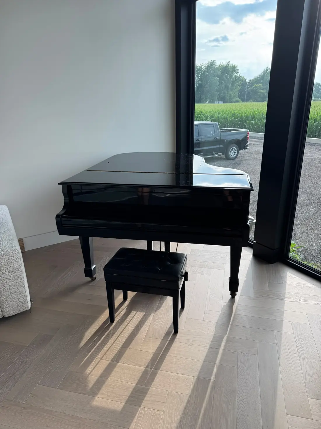 Grand piano with bench in a bright room