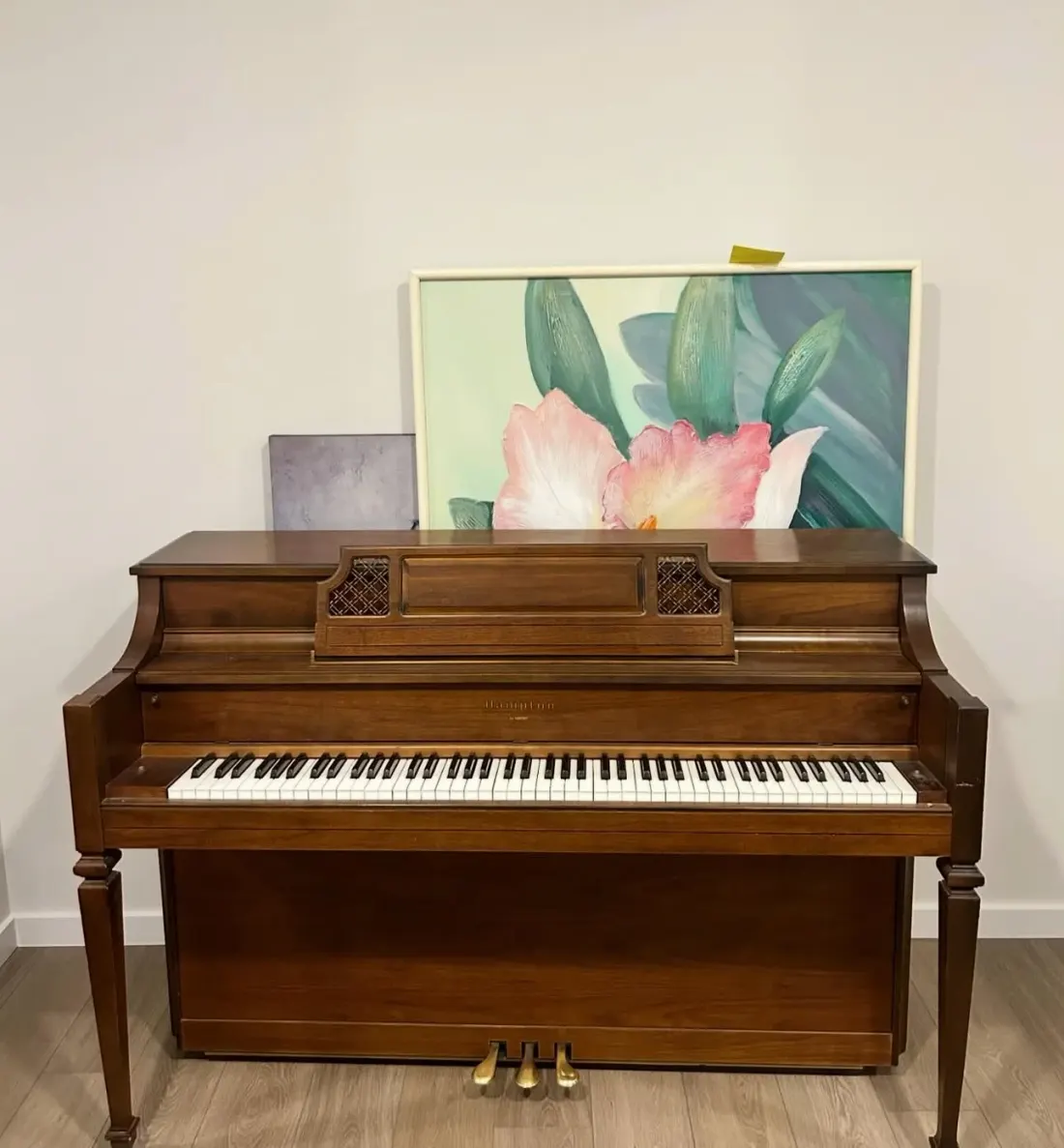 Walnut upright piano ready for an EC Movers piano move