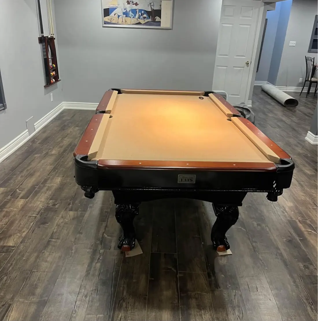 Pool table with fresh felt in a finished game room