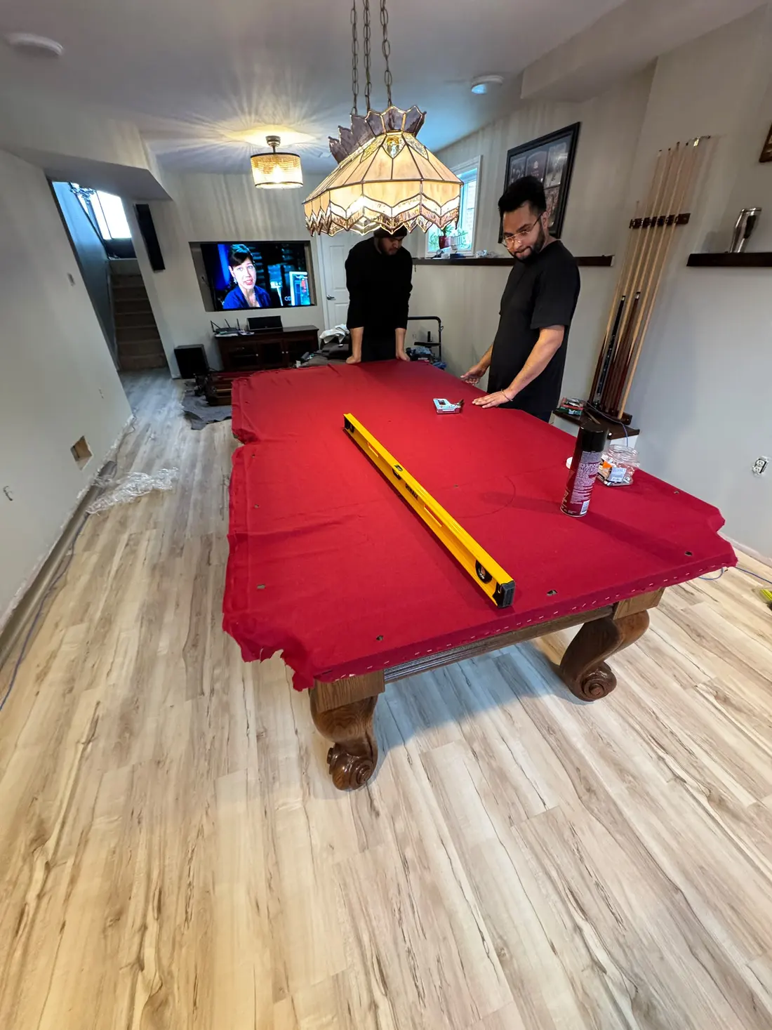 EC Movers crew levelling a pool table with a machinist level