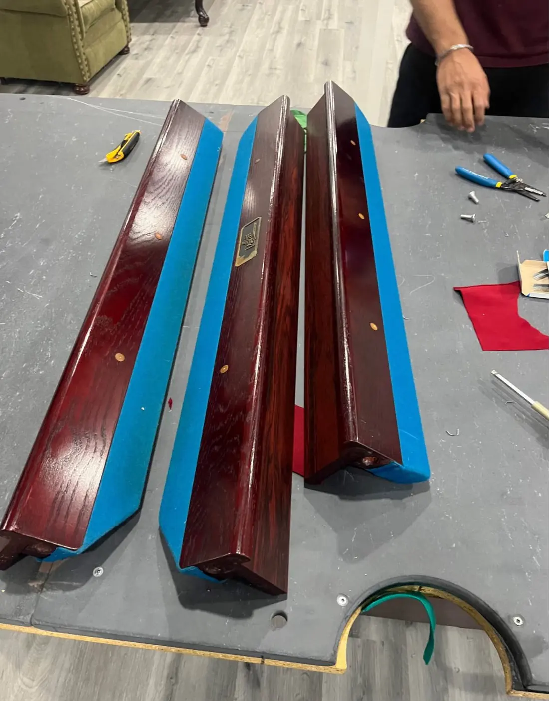 Pool table rails re-covered with blue cloth