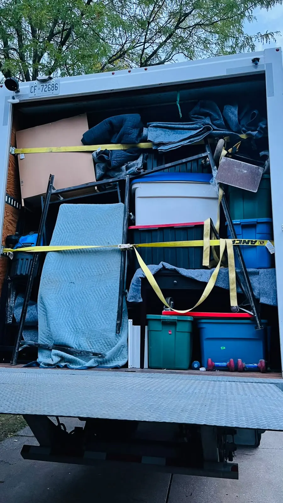 Truck loaded with totes and padded furniture by EC Movers